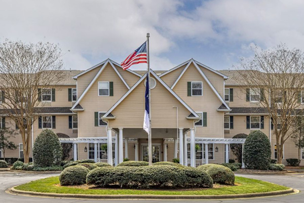 Exterior view of main entrance for Lake Wylie Assisted Living and Memory Care with American flag