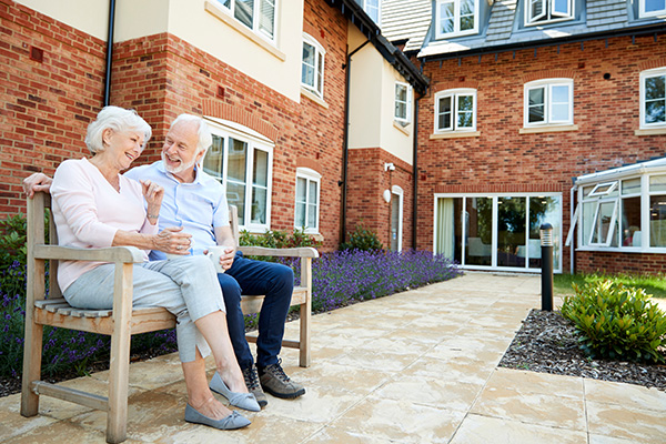Woman and Man sitting on bench smiling